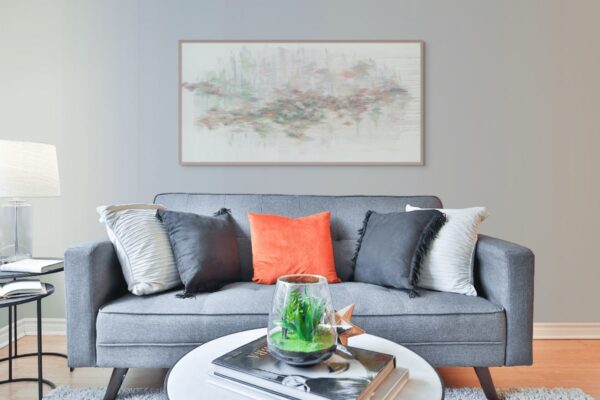 Framed painting of a tranquil pond with lilies reflecting Jerusalem’s silhouette in soft neutral tones, symbolizing peace, nature, and spirituality, displayed in a modern interior
