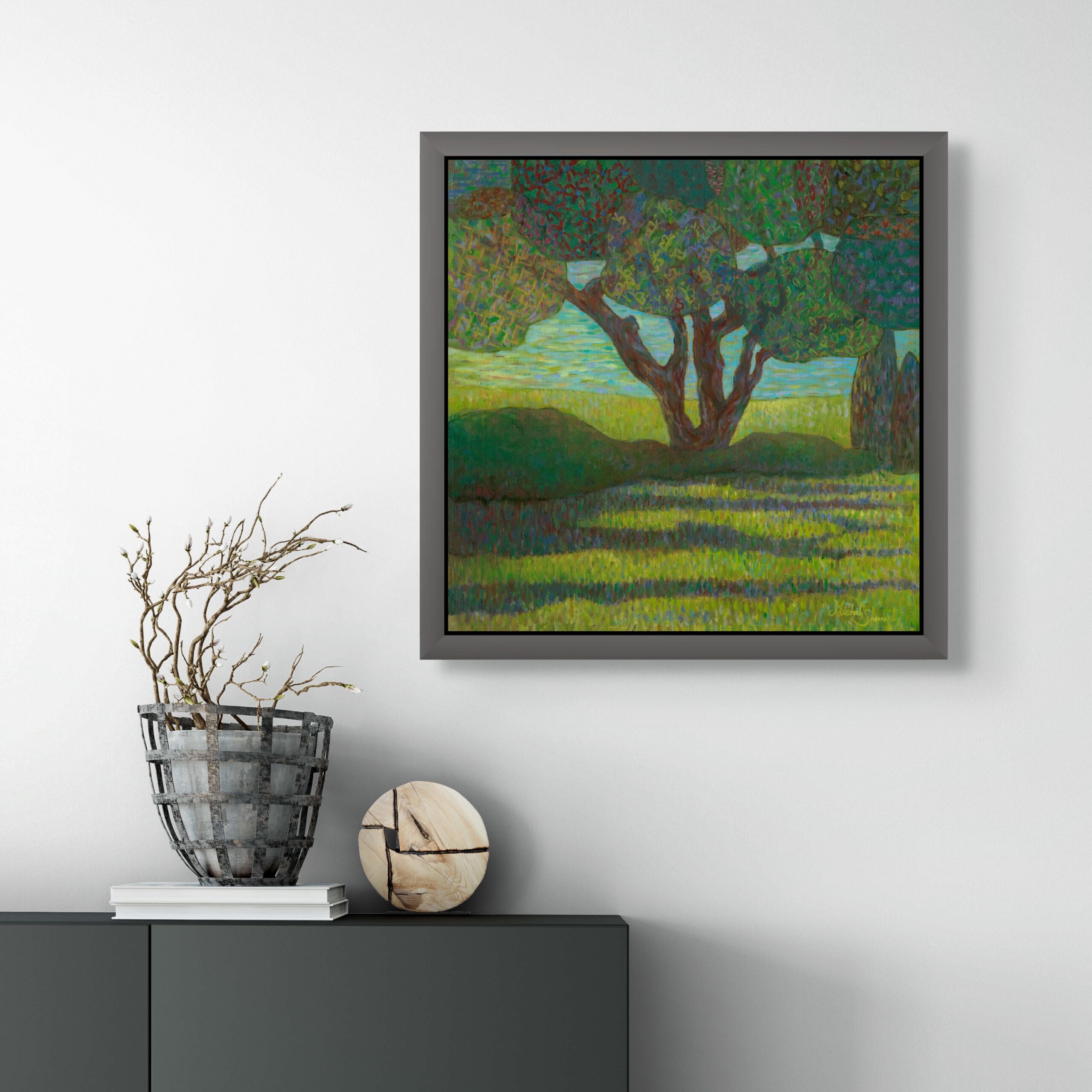 Colorful abstract tree painting with textile-like patterns in green shades, framed and displayed on a modern interior wall.